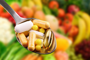 Dietary Supplements On Fruits Background